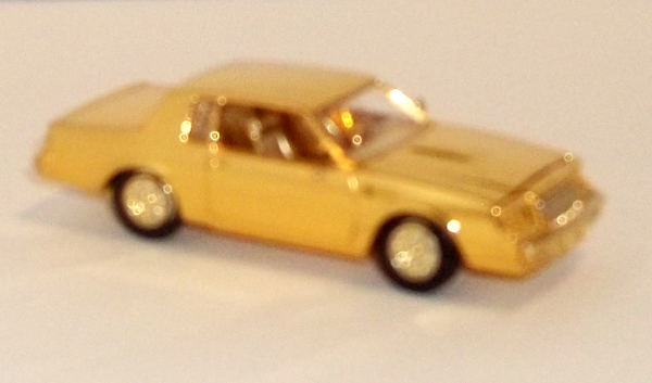 small, gold-plated car by Racing Champions