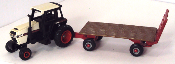 2294-Case Tractor with brown/red backrack on flat trailer (turning-left side)