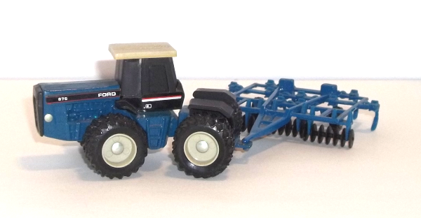 Blue Ford 876 tractor with blue harrow left side closeup