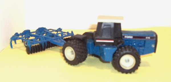 Blue Ford 876 Tractor with blue harrow (right side view)