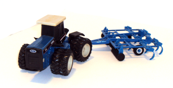 Blue Ford 876 Tractor with dual wheels - turning blue harrow (more front view)