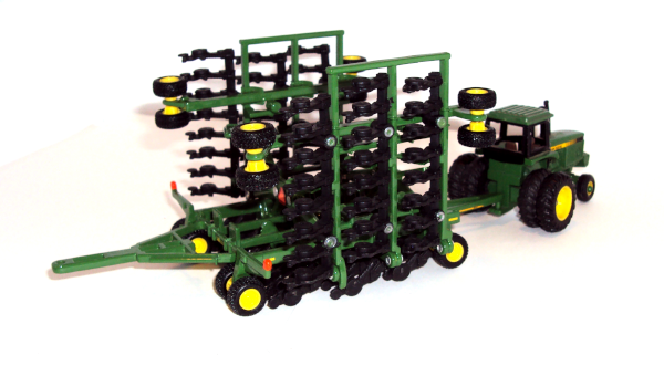 John Deere tractor with 637 disc-drill with hydraulic wings lifted up