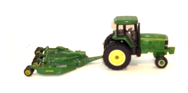 John Deere tractor with a green Paladin attachment