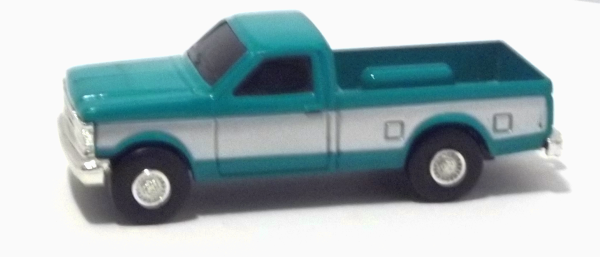 1990 Ford Pickup F250 teal with silver sides (left view)