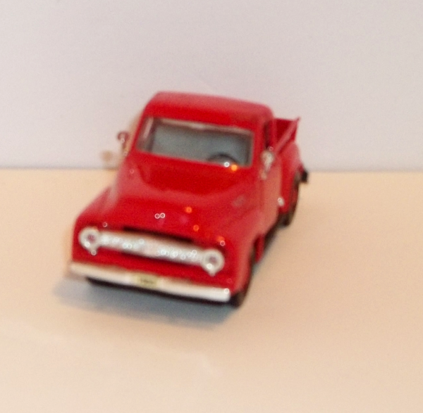 front view of a red Ford F100 1956 pickup truck by Road Signature