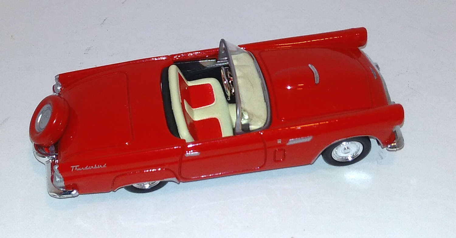 red Ford 56 Thunderbird coupe with red trimmed tire on end of trunk above view