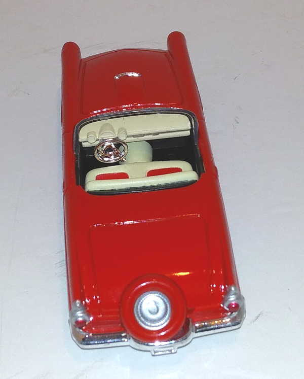 red Ford 56 Thunderbird couple with red-rimmed tire on trunk (rear-above view)