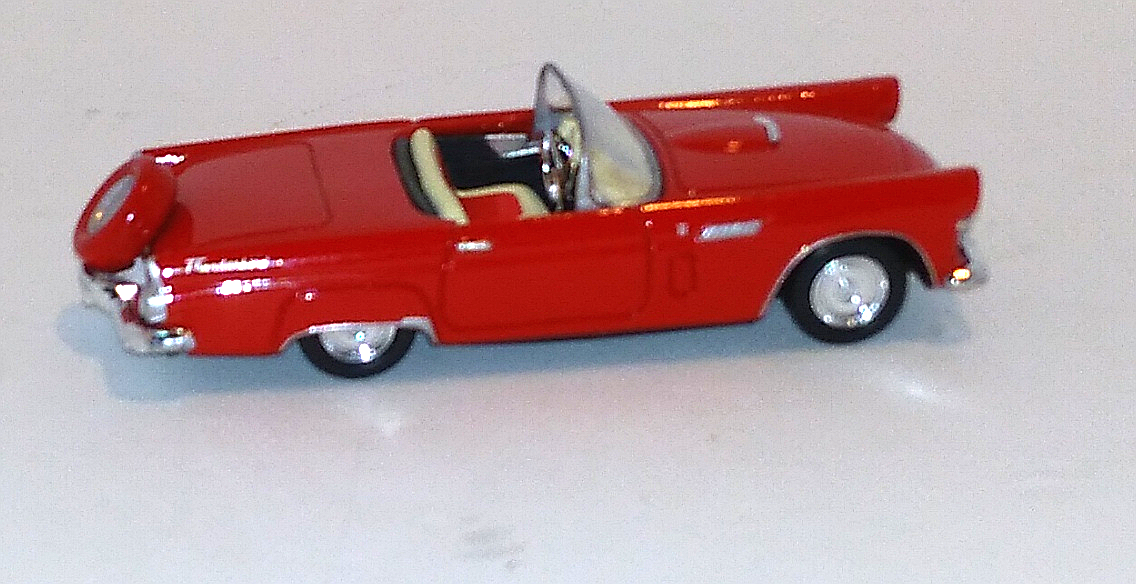 red Ford Thunderbird coupe with red rimmed tire on end of trunk  (viewed right side & above)
